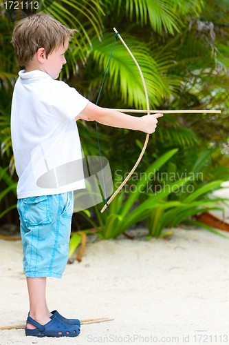 Image of Cute boy playing with bow and arrows