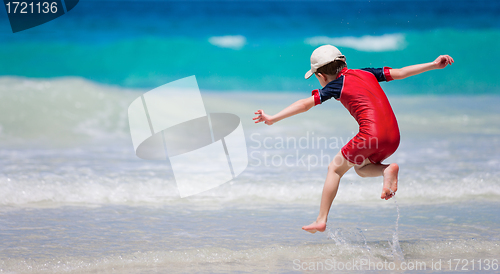 Image of Little boy having fun at beach