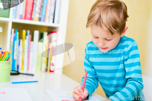 Image of Portrait of happy schoolkid at home