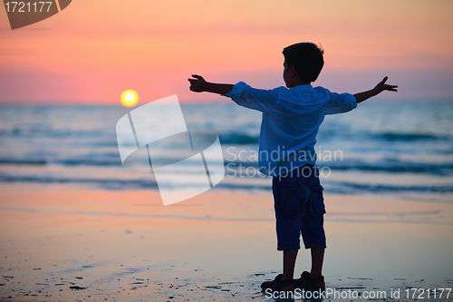 Image of Little boy at sunset