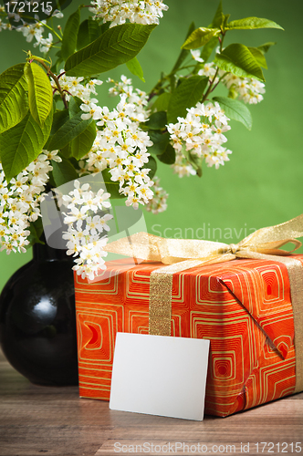 Image of Branch blossoming a spring tree and a box with a gift