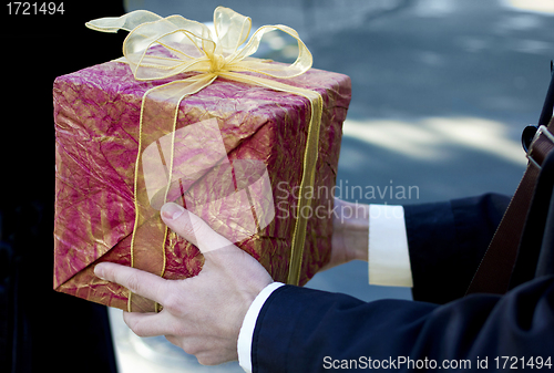 Image of Man present red gift box