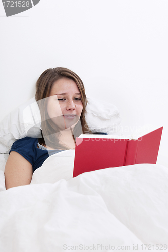 Image of Woman reading in bed