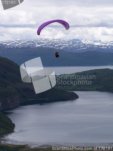 Image of Paragliding over sea with mountains in the background