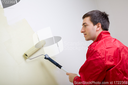 Image of Man painting a wall