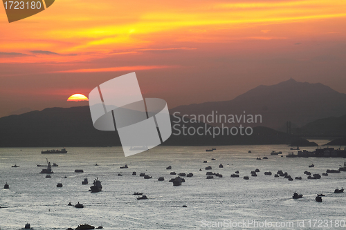 Image of ships at sunset in the sea 