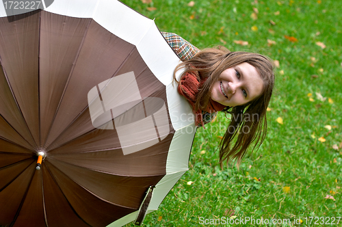 Image of Beautiful young woman with umbrella