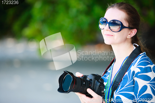 Image of Portrait of beautiful woman with camera