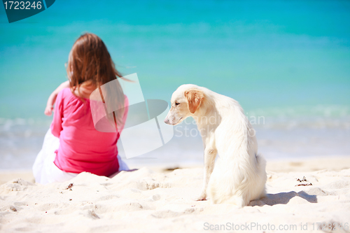 Image of Family with white dog on tropical beach
