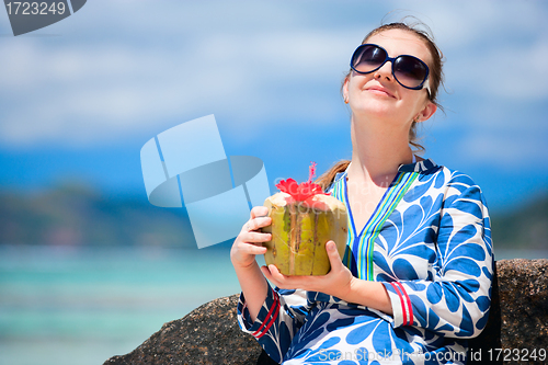 Image of Young woman with coconut