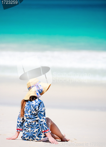 Image of Young woman relaxing on beach