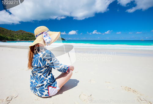 Image of Young woman relaxing at beach