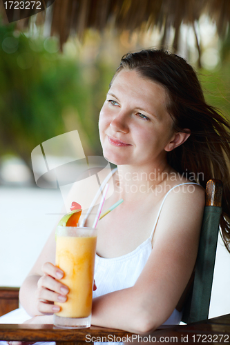 Image of Young beautiful woman drinking fresh fruit juice