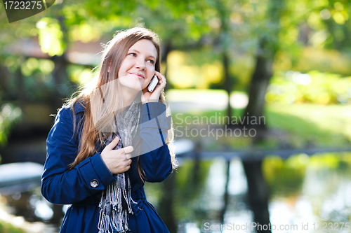 Image of Attractive young woman with mobile phone