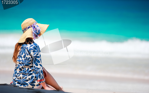 Image of Young woman relaxing on beach?