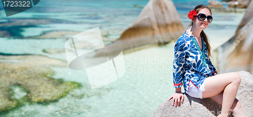 Image of Woman sitting on top of granite rock