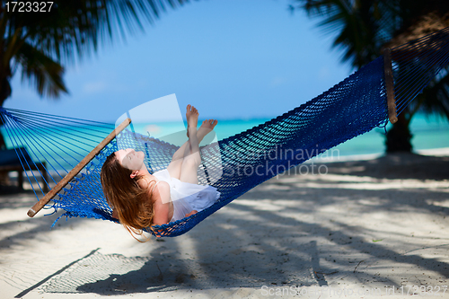 Image of Woman relaxing in hammock