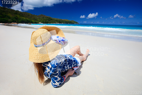 Image of Young woman relaxing at beach