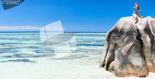 Image of Woman sitting on top of granite rock