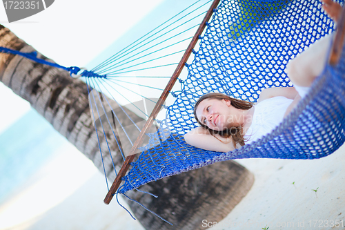 Image of Woman relaxing in hammock