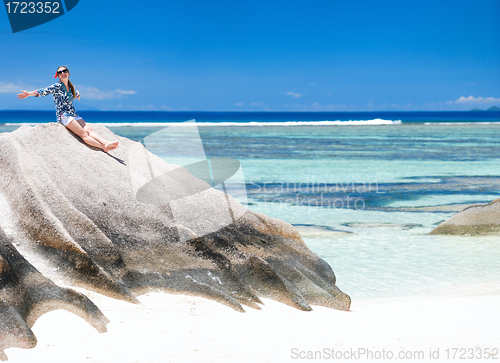 Image of Woman sitting on top of granite rock