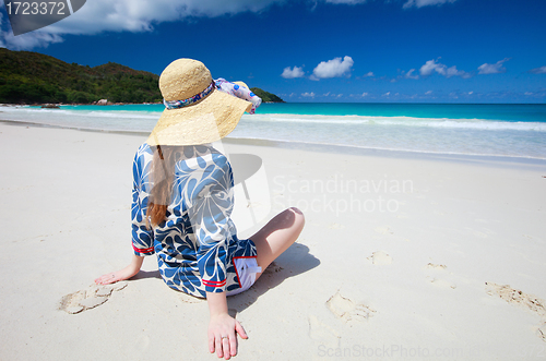 Image of Young woman relaxing at beach