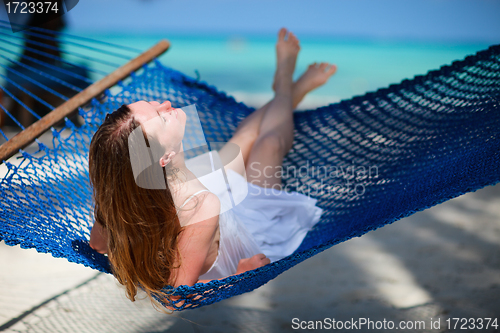 Image of Woman relaxing in hammock