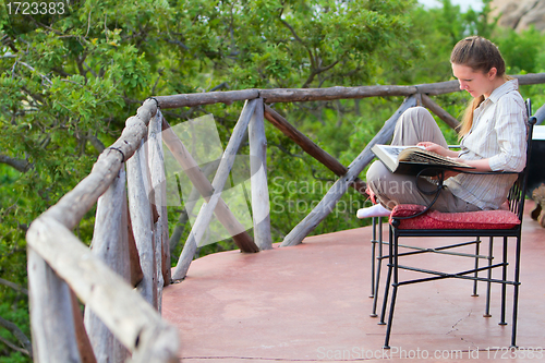 Image of Woman reading outdoors