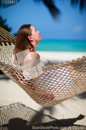 Image of Woman relaxing in hammock