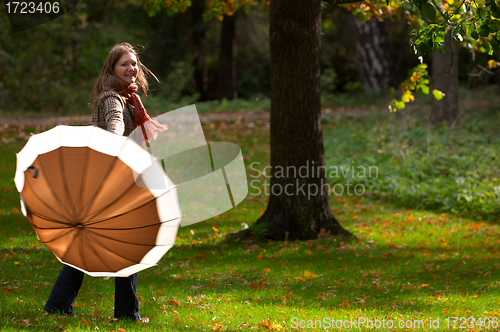 Image of Young woman with umbrella