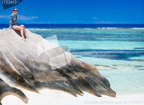 Image of Woman sitting on top of granite rock