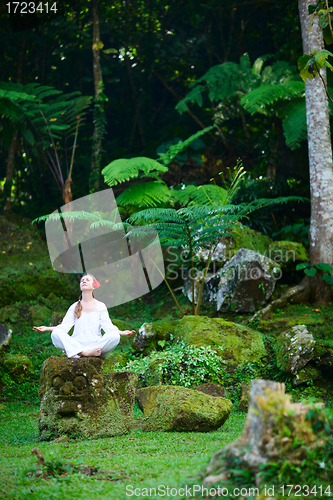 Image of Woman meditating outdoors