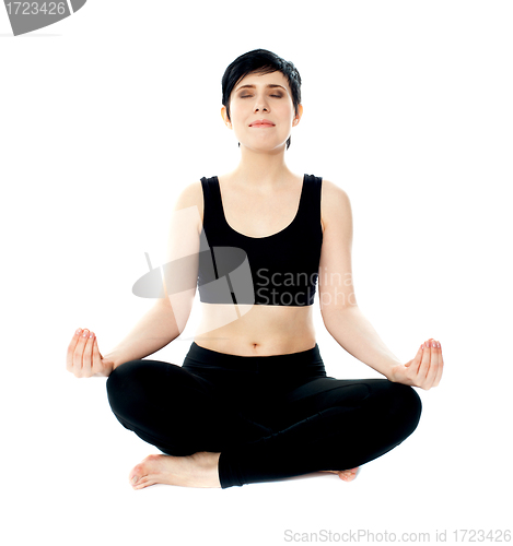 Image of Youung woman meditating in lotus pose