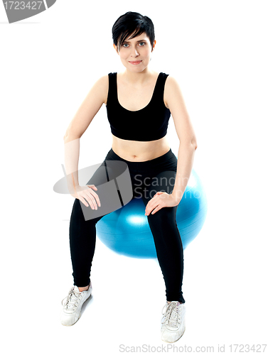 Image of Fitness woman isolated sitting on pilate ball