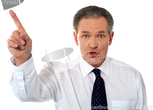 Image of Businessman pointing at copy space