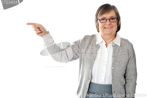 Image of Portrait of beautiful aged woman pointing