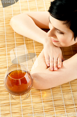 Image of Spa woman relaxing with a wine glass beside her