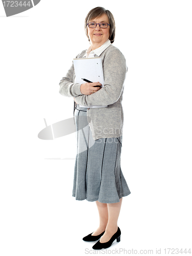 Image of Full length portriat of an aged woman carrying business documents