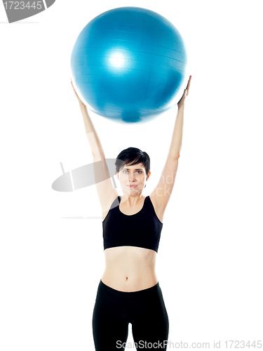 Image of Beautiful woman holding pilates ball