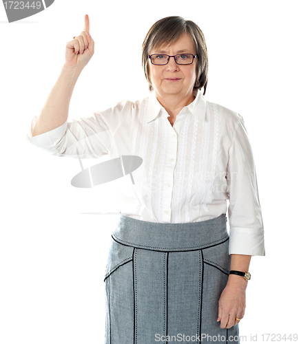 Image of Beautiful senior business lady pointing upwards