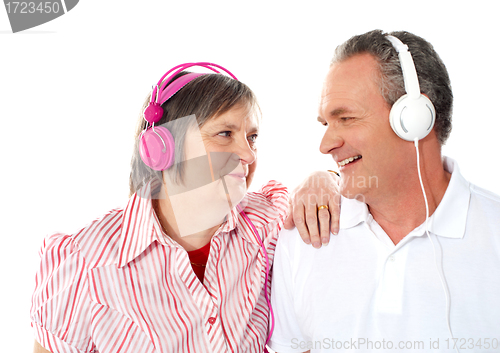 Image of Romantic senior couple enjoying music together