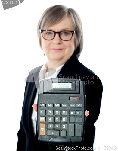 Image of Business professional showing calculator to camera