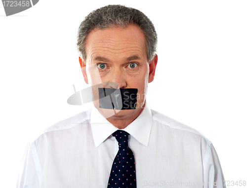 Image of Businessman with taped mouth