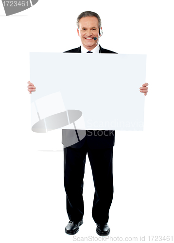 Image of Businessman holding a blank billboard