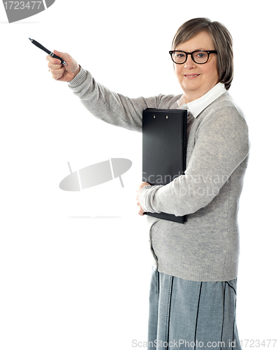 Image of Female executive pointing away with pen in hand