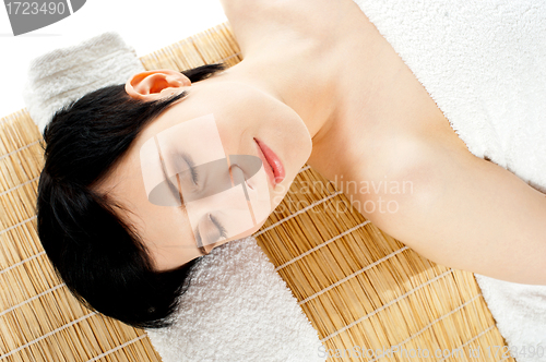 Image of Closeup of a gorgeous girl relaxing at spa