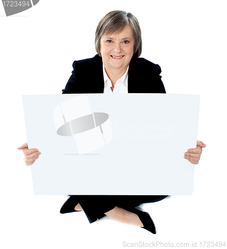 Image of Corporate lady sitting on floor with a blank billboard