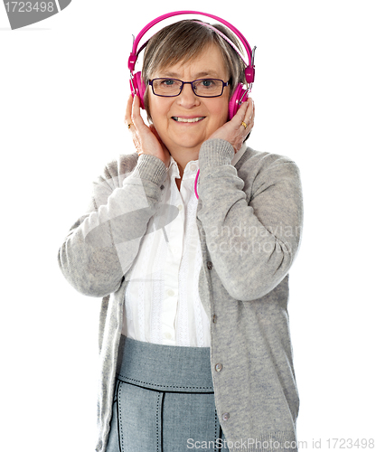 Image of Attractive old lady wearing headphones