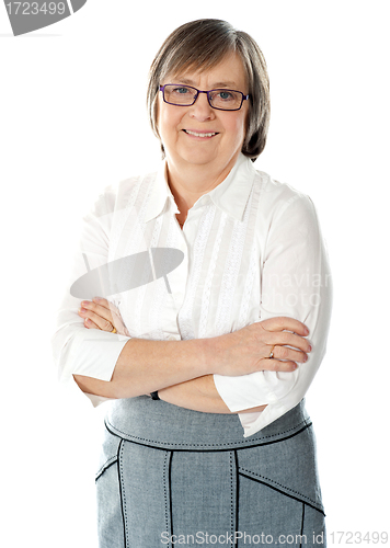 Image of Smiling attractive old lady posing with arms crossed