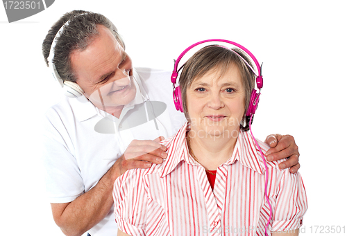 Image of Aged couple enjoying music over white background